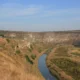 Church with a bell tower on the cliff above a bend of the Răut river at Orheiul Vechi